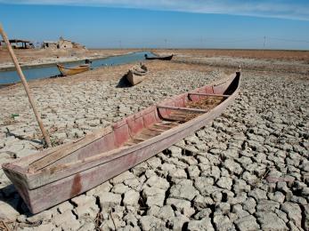 A abandoned boat on dry marshland during a drought in southern iraq.