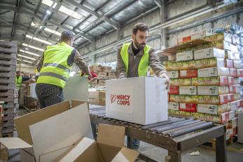 Humanitarian aid shipment being prepared in warehouse.
