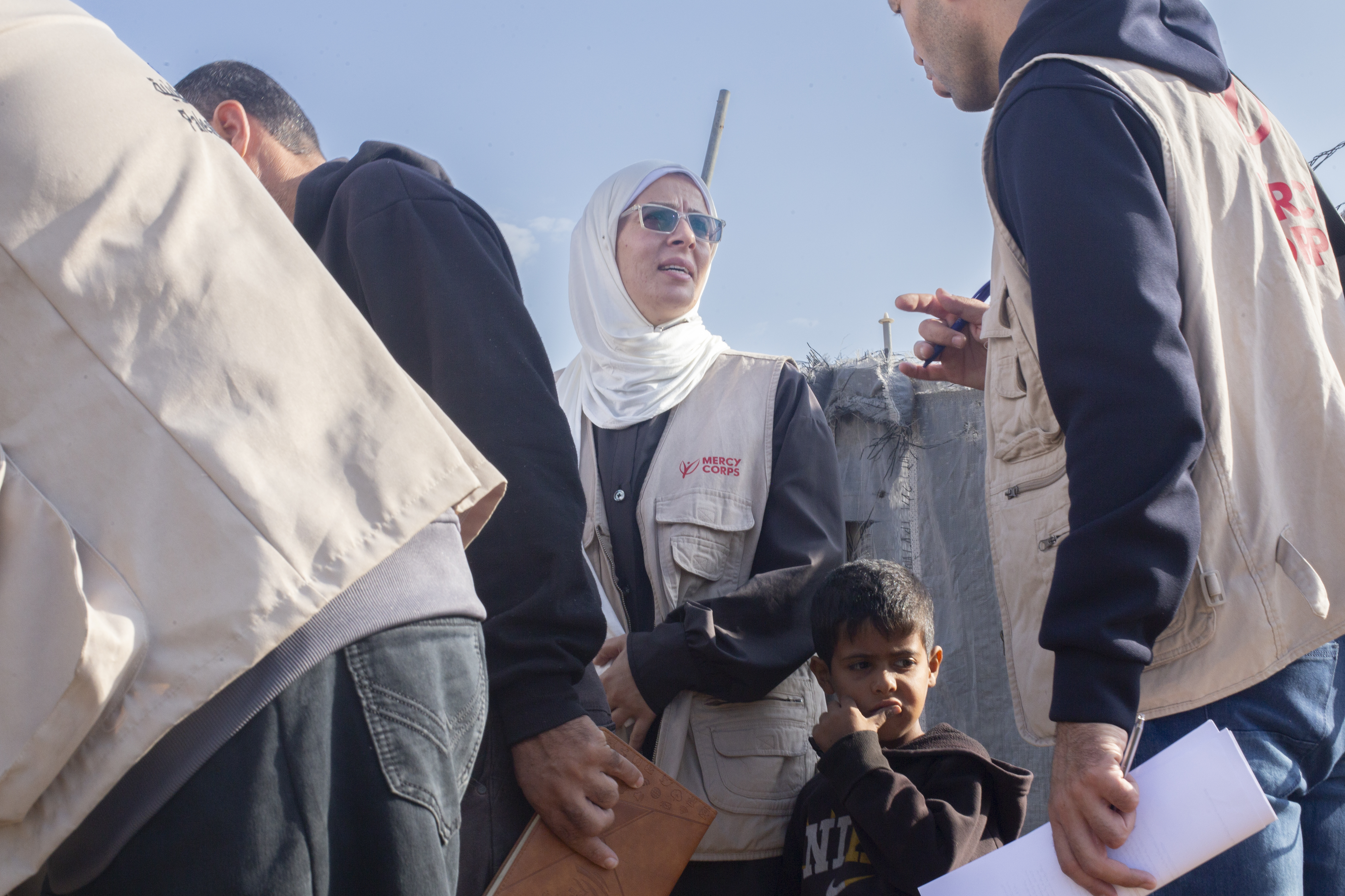 Image of mercy corps aid worker among a group of other aid workers.