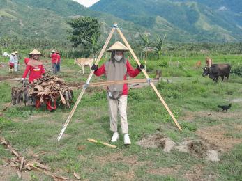 Women work together on a farming resilience project outdoors in agricultural setting.