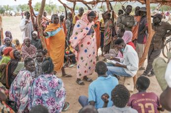 Families in sudan wait to register for a food aid delivery.