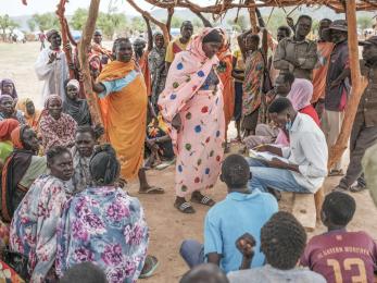 Families in sudan wait to register for a food aid delivery.