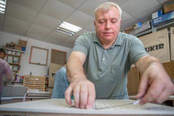 A person assembles a ceramic heating plate.