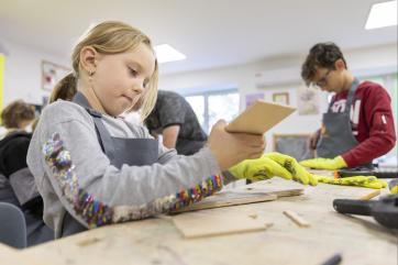 Ukrainian children working on art projects in community center.